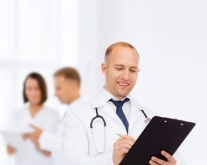 Doctor in white coat holding clipboard