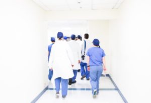 Team of doctors walking to operating room Team of doctors walking to operating room